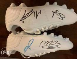 Signed football shoes by Messi, Ronaldo, M...