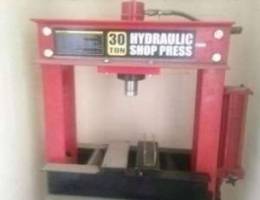 Hydraulic press and welding machine