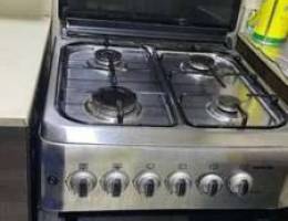 Gas cooker and cylinder with regulator.