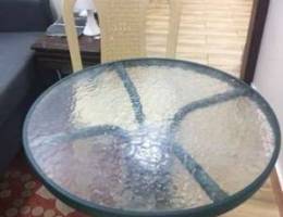 Glass table with two plastic chairs